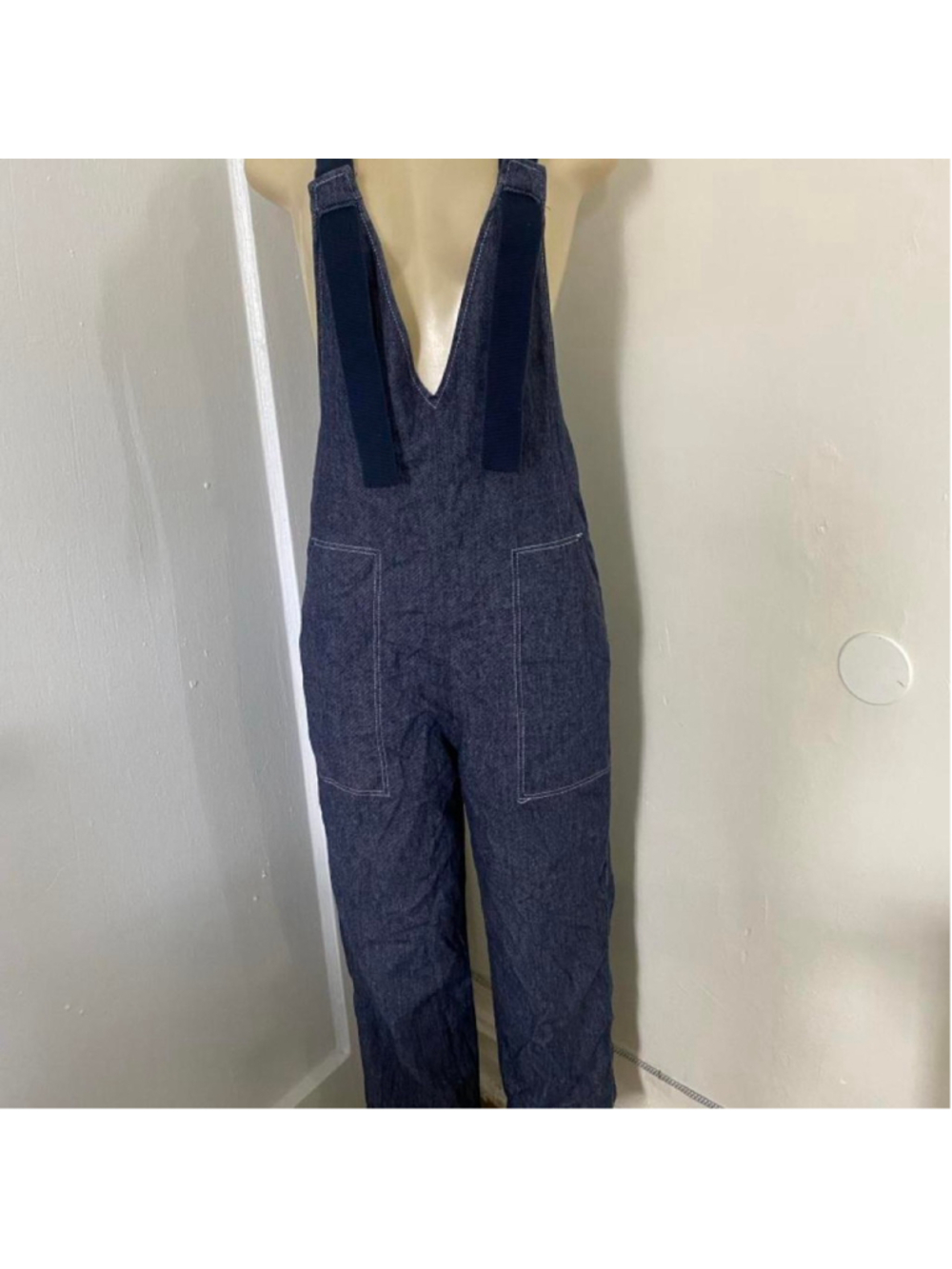 Navy blue denim overalls with a relaxed fit